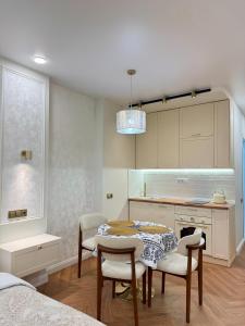 a kitchen with a table and chairs in a room at NBG d 'amore Appart in Batumi
