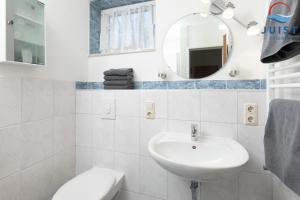 een witte badkamer met een wastafel en een spiegel bij Töwerland Zimmer 2 in Juist +6 foto's