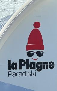 a sign on the side of a boat with a hat and sunglasses at Appartement - La Plagne - Les Coches - 7 Personnes - Pieds des pistes in La Plagne Tarentaise +51 photos