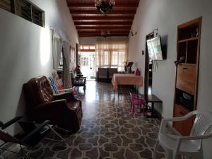 a living room with a couch and chairs and a table at Villa YARA in Chinácota