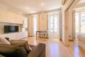 a living room with a couch and a tv at Lovely apartment temporal Madrid Centro SBE282D in Madrid