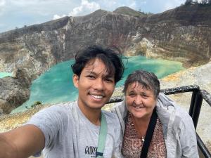 a man and a woman standing in front of a mountain at Lanina homestay in Ipi