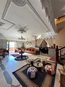 a living room with a couch and a table at Riad Dar Fadma in Ouarzazate +136 photos