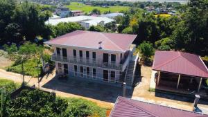 an aerial view of a white house with a red roof at Hollanda Recidencia Apartment Hotel in Bangued