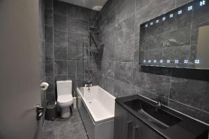 a bathroom with a sink and a toilet and a bath tub at Central, Contractor&family Friendly, Smarttv in Sunderland