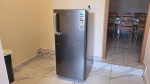 a stainless steel refrigerator sitting in a room at NewCastle Holidays Resorts-Entire Property 5 Bedrooms-Great Mountain & River View-Between Munnar & Idukki with Kitchen in Idukki