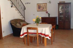 a dining room table with a vase of flowers on it at Assisi Casa Vacanze Da Luigi in Assisi +31 photos