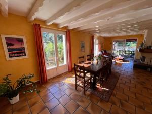 a dining room with a table and chairs in it at Villa Valhalla - 400m from beach, sauna and big heated pool in Labenne