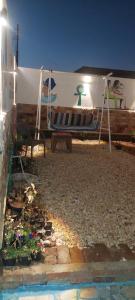 a swing in a yard with a tent and flowers at ZAIN PALACe in Jazīrat al ‘Awwāmīyah