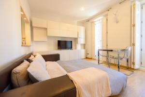 a large bed in a room with a couch at Lovely apartment temporal Madrid Centro SBE282D in Madrid