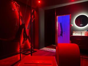 a red room with a mirror and a dressing room at bulles de plaisir in Saint-Maurice-lʼExil