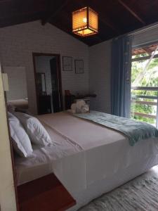 a large white bed in a bedroom with a window at Villa in Governador Celso Ramos +38 photos