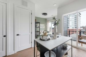a kitchen with a table and a large window at Jade Junction in Atlanta