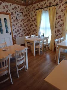 a dining room with tables and chairs and a window at Sleepy Hollow B&B in Donegal