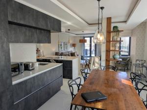 a kitchen and dining room with a wooden table in a kitchen at The Old Fire Station Luxury Apartment in York