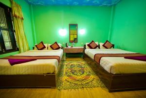 Voodi või voodid majutusasutuse Chitwan Gaida Lodge - Animal Lovers & Birdwatchers Paradise toas