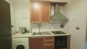 a kitchen with a sink and a stove top oven at apt via cernaia rome center in Rome