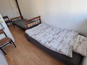 a bedroom with a bed with a sheet with music on it at Konkrety Lubin in Lubin