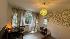a living room with a table and a window at Lake House Hostel in Szczecin