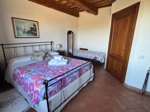 a bedroom with a bed and a door to a room at Agriturismo Podere Marcampo in Volterra