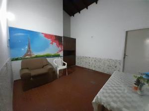 a room with a couch and a chair and a painting at Quintana in Asunción