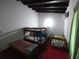 a room with three bunk beds in a room at Quintana in Asunción