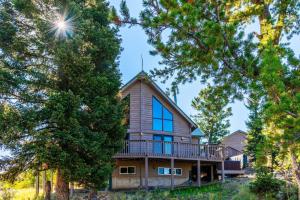 a house with a wrap around porch with trees at Warm Mountain Escape Secluded Peaceful Hot Tub in Bordenville