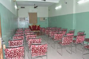 a room with a bunch of red chairs in a room at Hotel Naveen Residency in Darbhanga