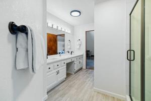 a white bathroom with two sinks and a shower at Spacious Keystone Family Escape Great Location in Keystone +60 photos