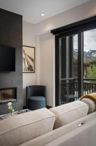 a living room with a couch and a fireplace at Brand New Mountain Modern Westin Amenities Views in Avon