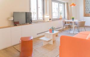 a living room with a couch and a tv and a table at Le Gabriel in Strasbourg +81 photos