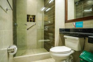 a bathroom with a toilet and a glass shower at ILAR 74 Coliving & Hotel Avenida Chile Bogota in Bogotá