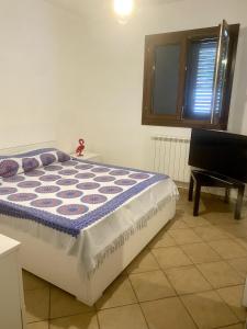 a bed in a room next to a piano at Casa Vacanze - Villa Claudia in Leporano Marina