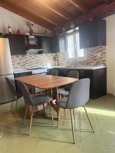 a kitchen with a wooden table and chairs at Country House in Kanakádes