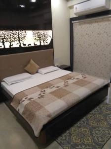 a large bed in a room with a window at The luxe Aravali in Udaipur
