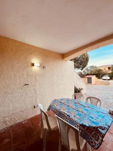 a table and chairs on a patio with a table and a view at Elena's apartment in Cannigione