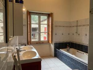 a bathroom with a sink and a tub and a window at Château du Bouy in Champétières +42 photos