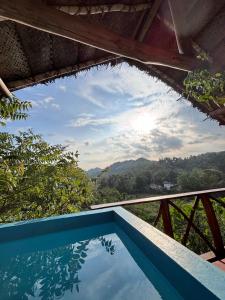 a swimming pool with a view of the sky at Dins Nature Villa in Elgiriya