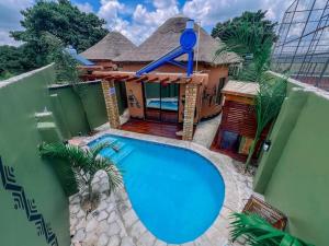 een groot blauw zwembad voor een huis bij Twalumba Resort & Village in Mwanachunga