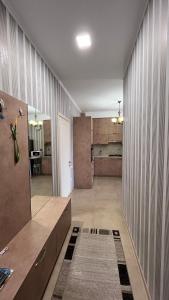 a large room with a hallway with a kitchen and a room with at Apartment Katya in Batumi +9 photos