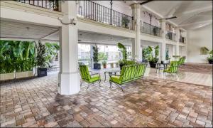 a lobby with green chairs and a table at Palm Beach Modern Condo-Beach Attractions Nearby in Palm Beach