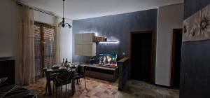 a living room with a table and a tv on a wall at Umberto House in Nizza Monferrato