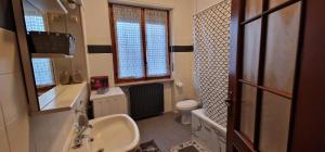 a small bathroom with a sink and a toilet at Umberto House in Nizza Monferrato +14 photos