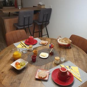 a wooden table with plates of food on it at Les Nymphéas in Saint-Lyphard +10 photos