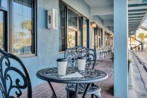 a table with two cups on top of it on a patio at Beachside Inn in Destin