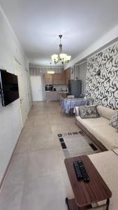 a living room with a couch and a table at Apartment Katya in Batumi