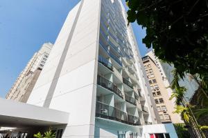 a tall white building with balconies at Studio - Setin Downtown Estação Luz - Sou House in São Paulo
