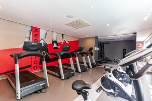 a gym with treadmills and cardio equipment in a room at Studio - Setin Downtown Estação Luz - Sou House in São Paulo +42 photos
