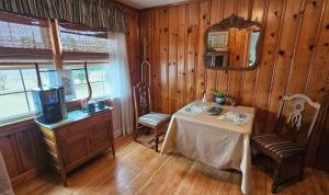 a dining room with a table and a mirror at A Salter's Path in Beaufort