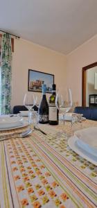 a table with glasses and bottles of wine on it at Princess house in Nizza Monferrato